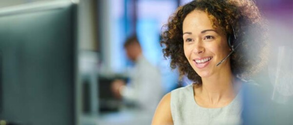 Smiling woman working in a customer service call centre.