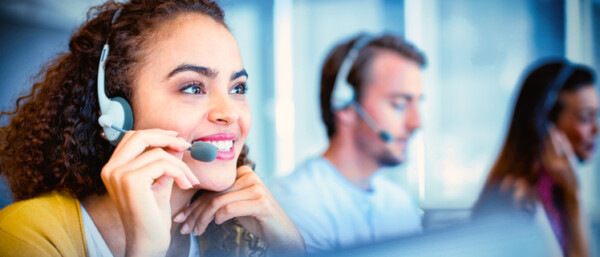Women using headset in customer service call centre.