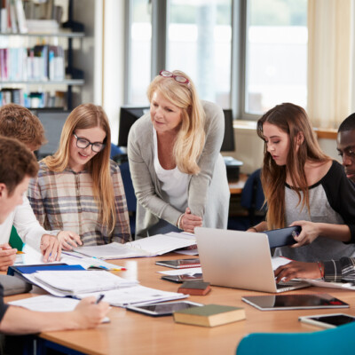 Female teacher working with college students