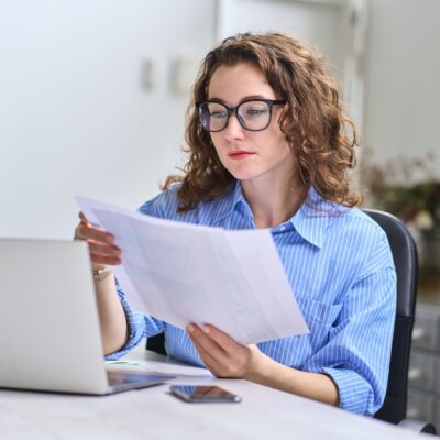Company employee holding accounting bookkeeping document