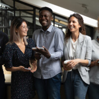 Rear view of a woman talking to coworkers