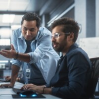 Two Software Engineers Discussing a Software Code
