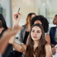 Business woman, hand up and questions at seminar,