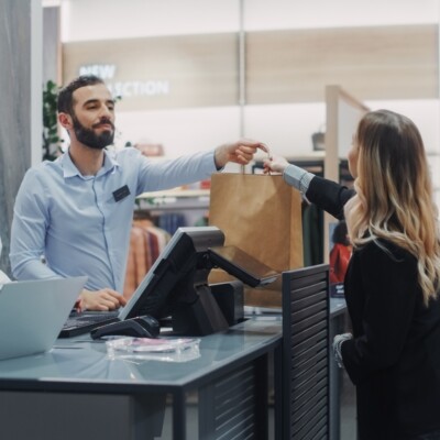 Clothing store checkout cashier with customer