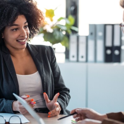 Colleague coaching or mentoring another colleague
