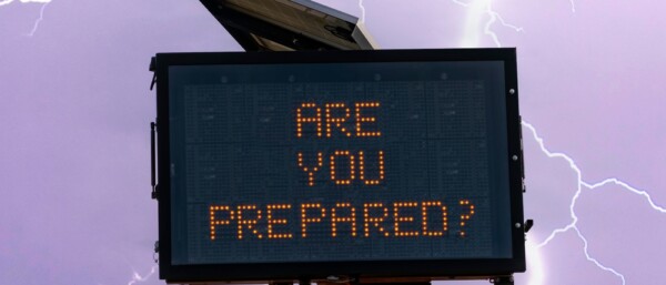 Photo illustration of digital road sign in front of lightning with text Are You Prepared ? to convey a concept of preparedness for severe weather and power outages.