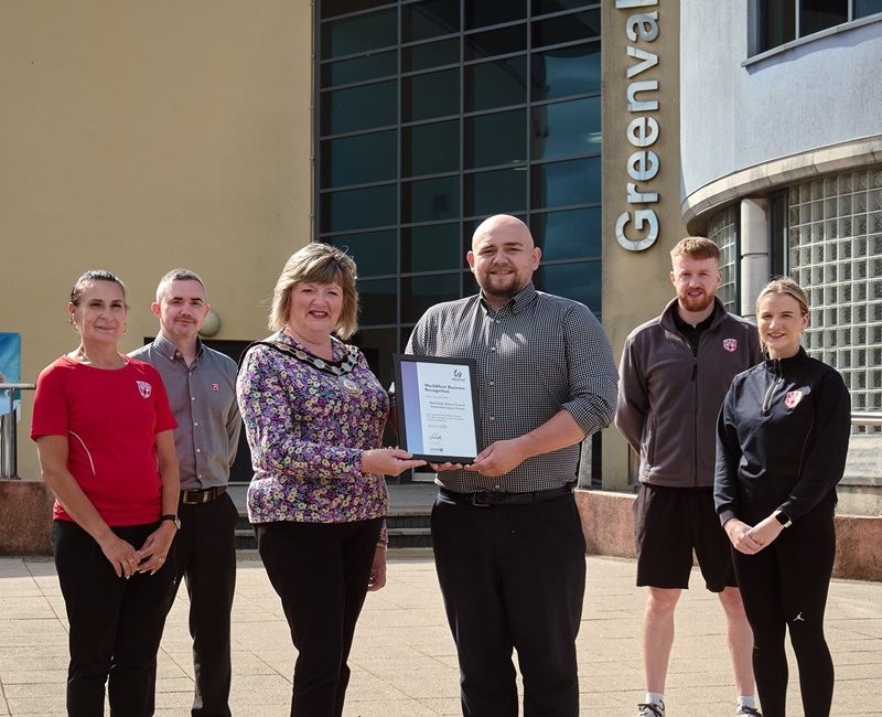 Staff from Greenvale Leisure Centre receiving a certificate