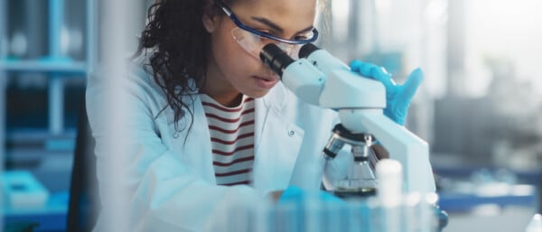 Medical Science Laboratory: Portrait of female scientist looking at microscope