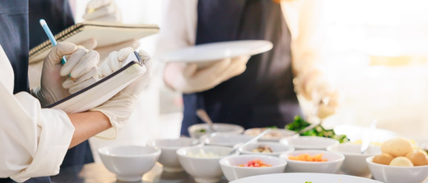 take note on book. Cooking class. culinary classroom. group of happy young woman multi-ethnic students are focusing on cooking lessons in a cooking school.